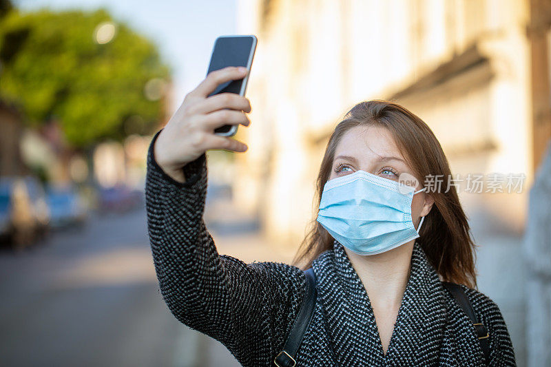 Young woman take a photo with mask on her face